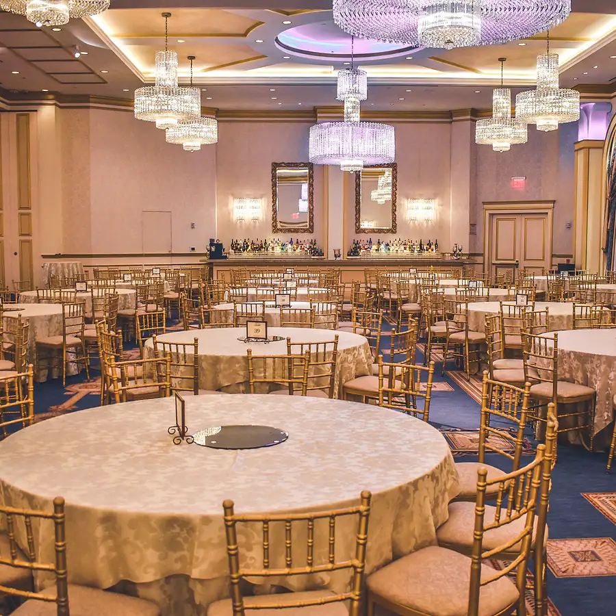 Ballroom set with round banquet tables and chandeliers