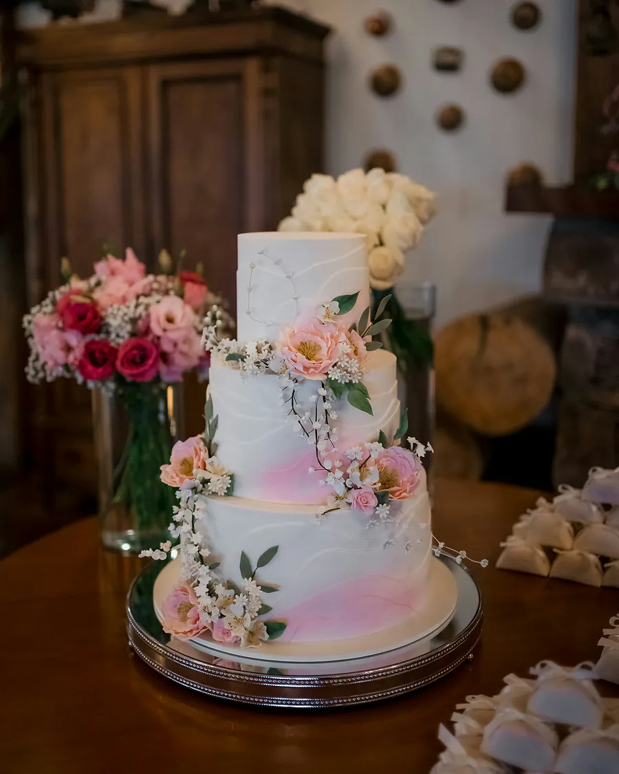 Three-tier white cake decorated with pink flowers